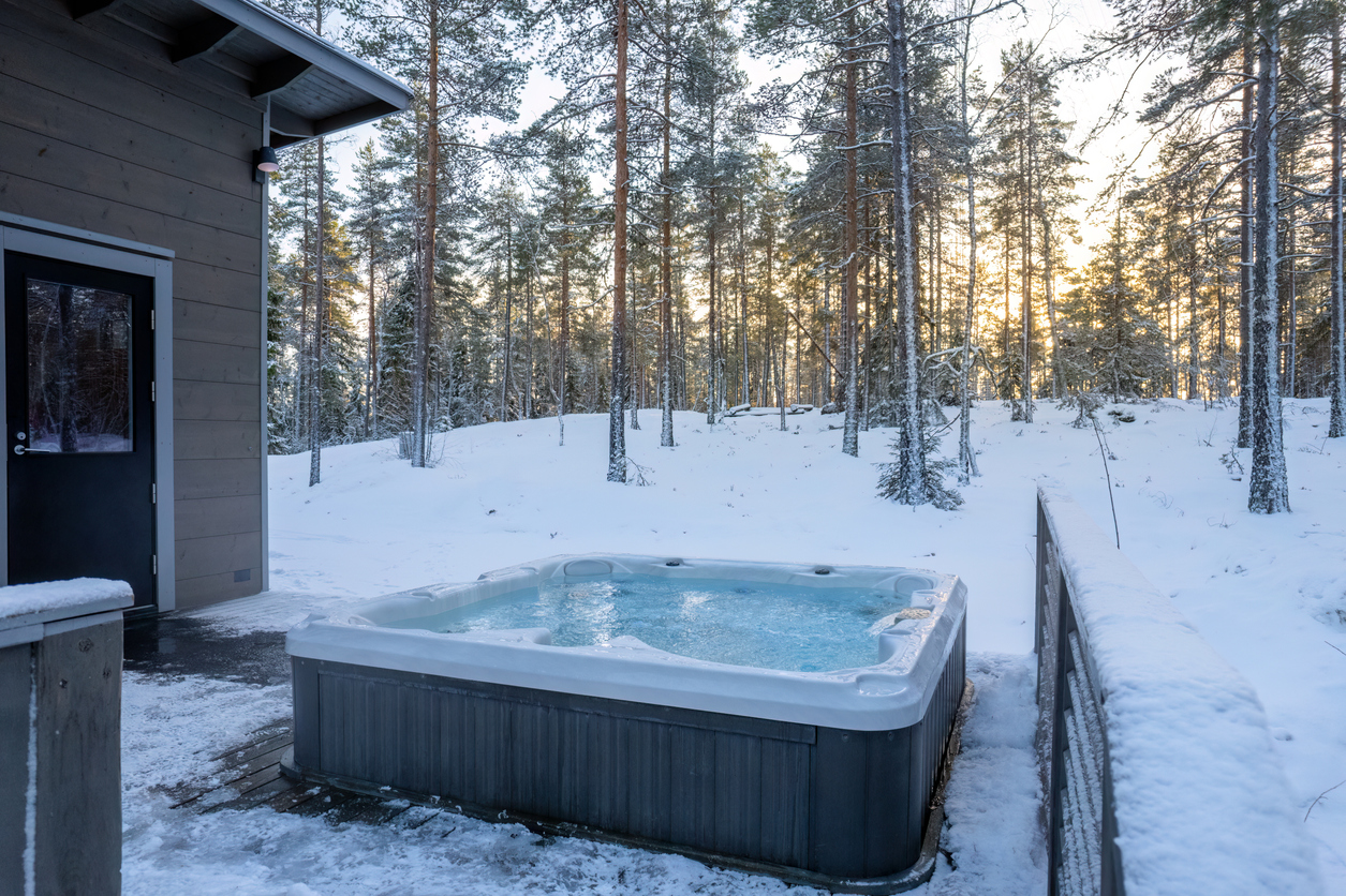 A warm hot tub in crisp winter weather at sunset.