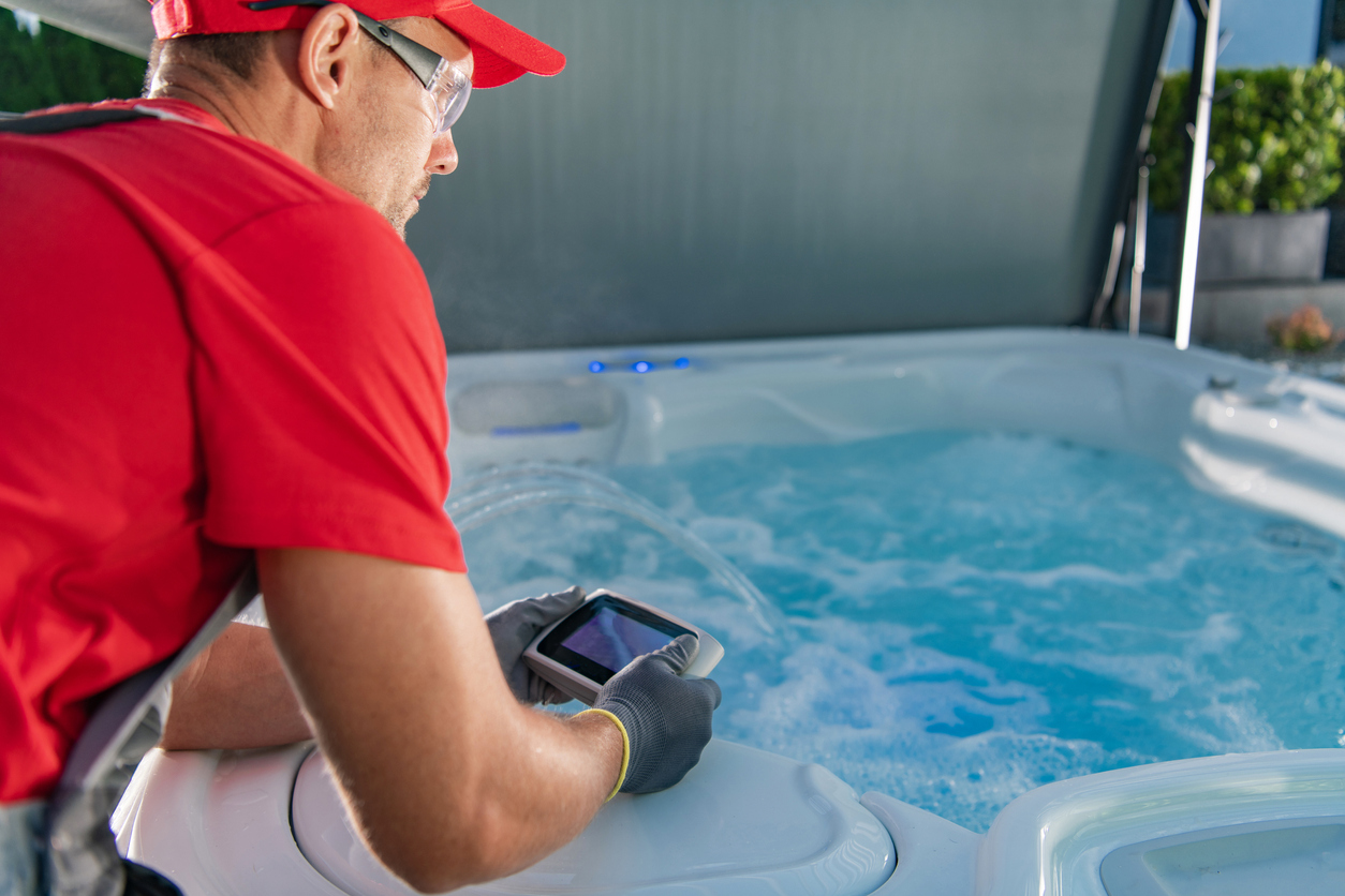 Caucasian Garden SPA Technician in His 40s Testing Hot Tub Remote Inside SPA Gazebos. 